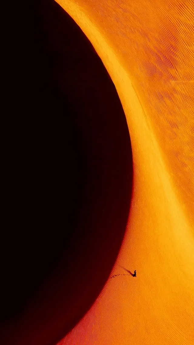 Orange and charcoal motion frame—Dune aesthetic, gradient-heavy, dark-mode, dark