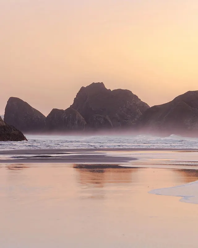 Misty coastal rocks at sunset, photographic, organic, warm