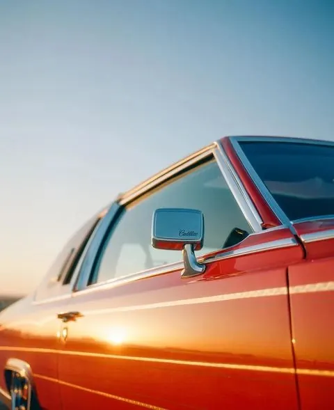 Cadillac chrome mirror golden hour, retro, photographic, warm