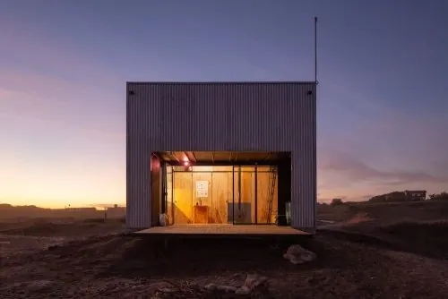 Corrugated cabin at coastal dusk, minimal, photographic, muted