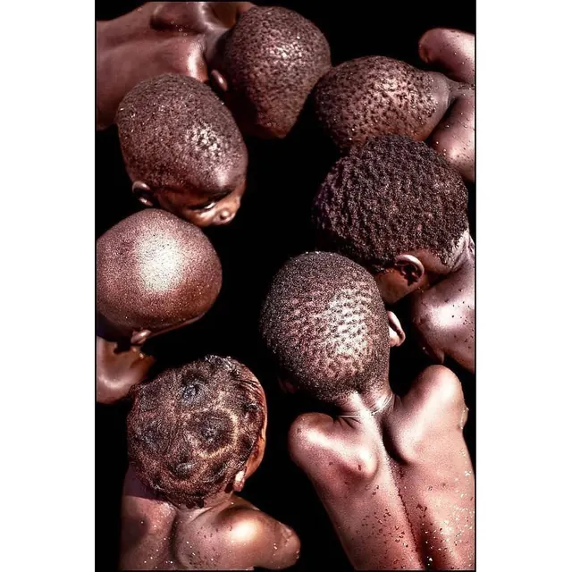 Chocolate truffles in hands with dramatic black background, photographic, product-photography, dark