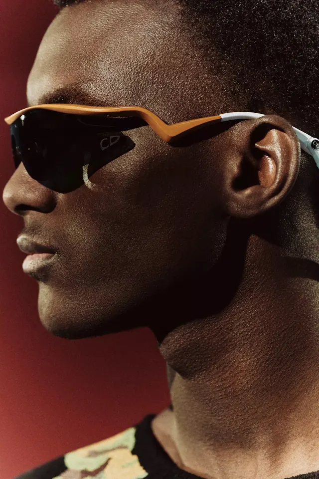Profile portrait with geometric sunglasses, photographic, minimal, vibrant