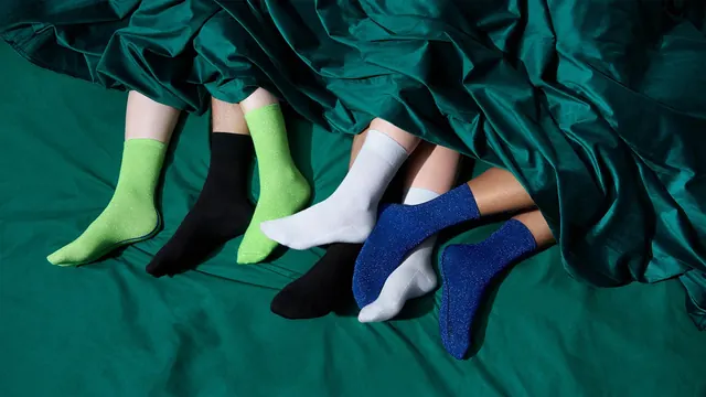 Glitter socks under green silk sheets, photographic, playful, vibrant