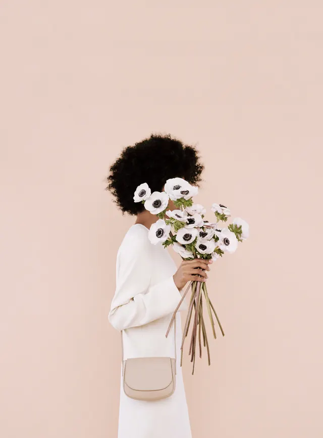 White anemones hiding a profile face, minimal, photographic, light