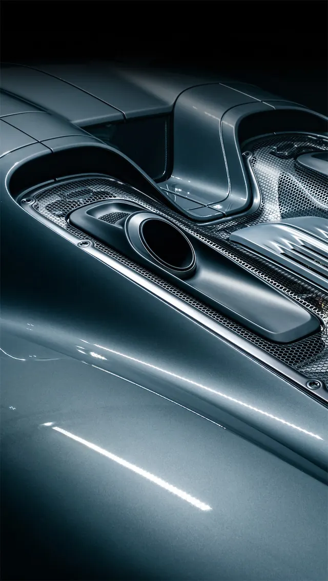 Supercar rear deck exhaust detail, technical, photographic, dark