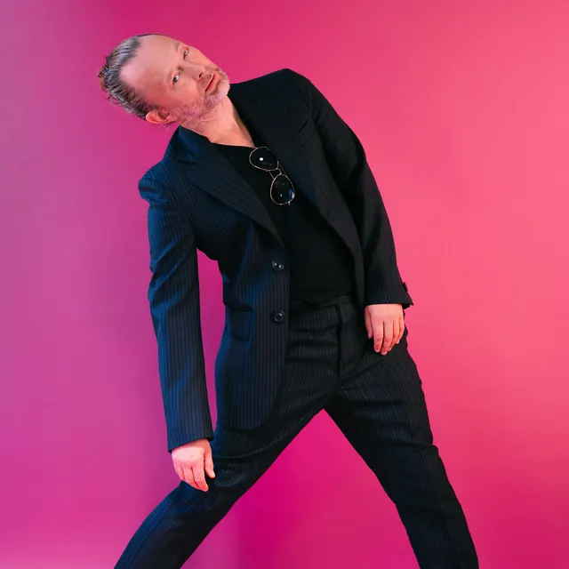 Thom Yorke magenta studio portrait, editorial, photographic, vibrant