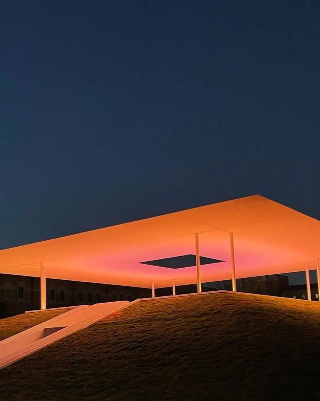 Skyspace pavilion orange glow at dusk, minimal, photographic, dark