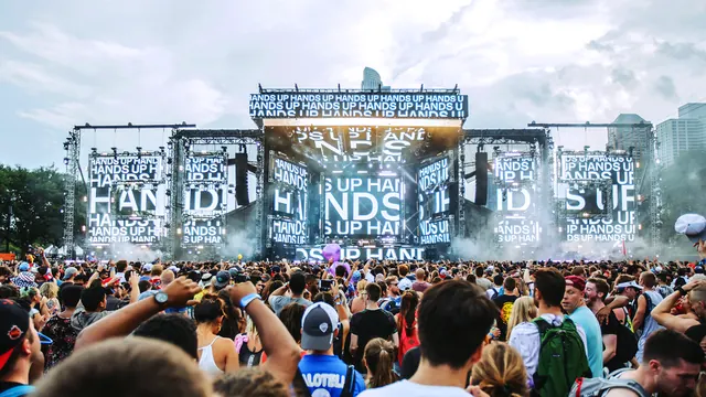 Festival crowd under HANDS UP LED stage, photographic, maximalist, light