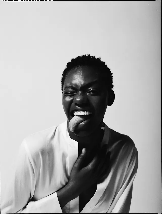 Portrait of a person smiling at camera, photographic, minimal, monochrome