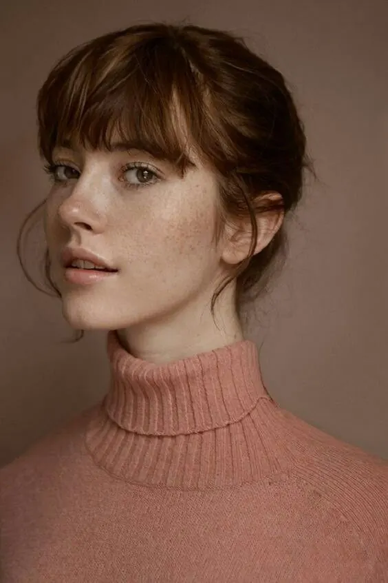 Monochrome beauty portrait with peach knitwear, photographic, minimal, warm