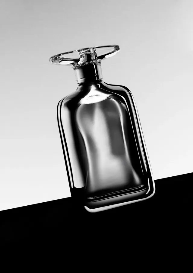 Minimalist monochrome perfume bottle on angled background, photographic, minimal, dark