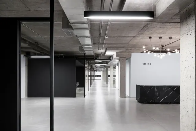 SSENSE headquarters reception interior, brutalist, minimal, muted