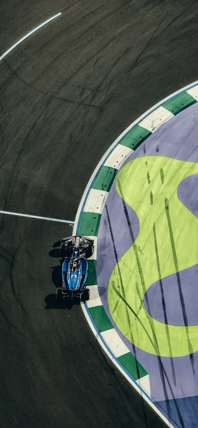 Aerial F1 car on colorful curbing, photographic, geometric, vibrant