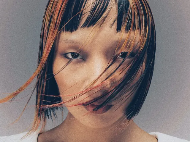 Editorial close-up with orange hair streaks, editorial, photographic, muted