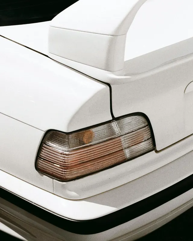 White BMW E36 taillight detail, minimal, photographic, light