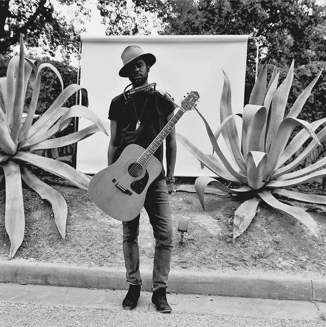 Musician portrait with agave backdrop, photographic, editorial, monochrome
