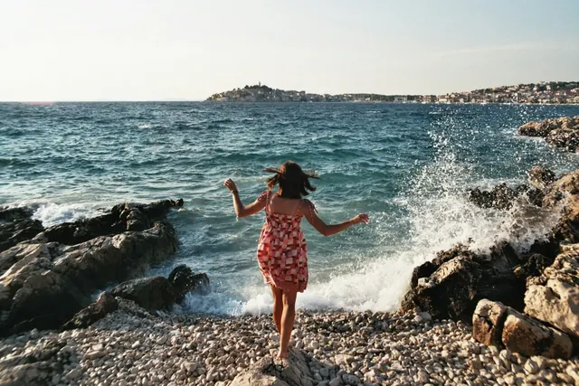 Woman on Rocky Coastline