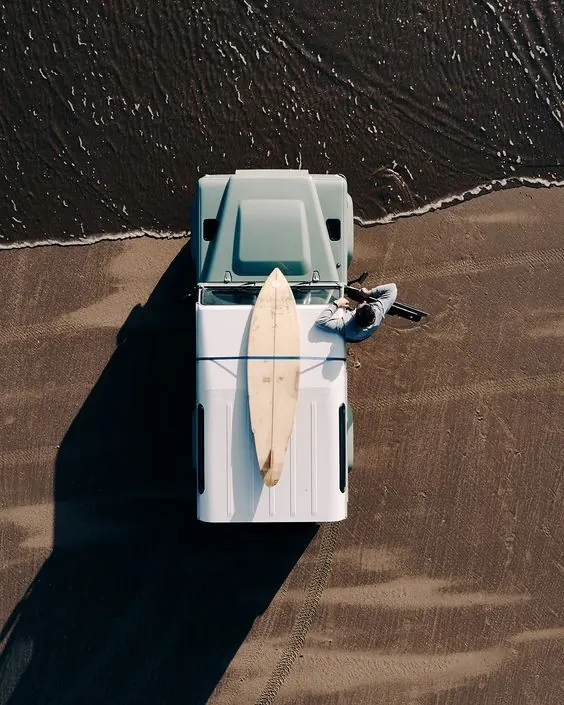 White Vehicle with Surfboard