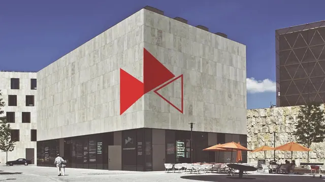 Architectural Building with Red Geometric Logo