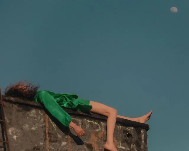 Person in Green Dress on Ledge