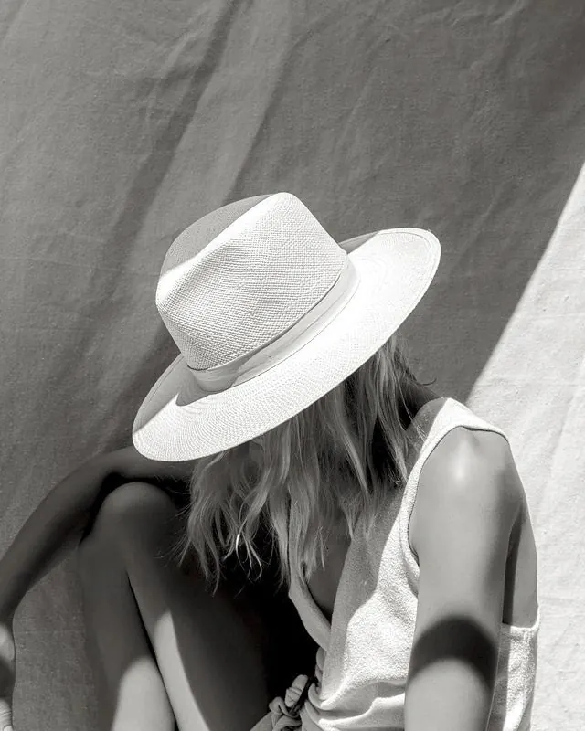 Woman in white straw hat portrait, photographic, minimalist, monochrome