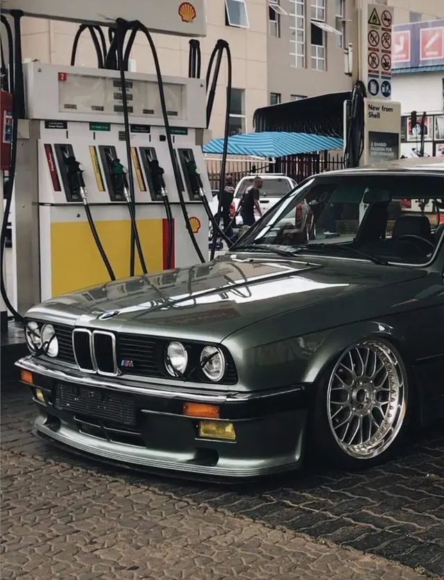 Vintage BMW at Shell gas station, photographic, retro, dark