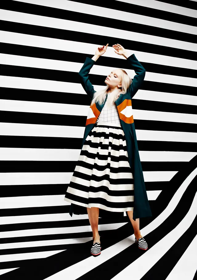 Fashion portrait with graphic striped background, photographic, bold, high-contrast