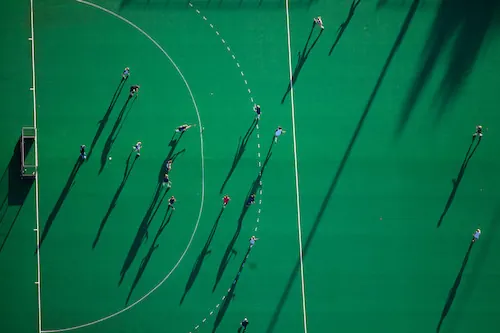 Aerial sports field view with players and geometric lines, photographic, geometric, monochrome