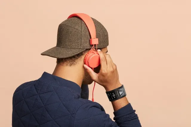 Lifestyle product shot with headphones and wearables, photographic, minimal, warm