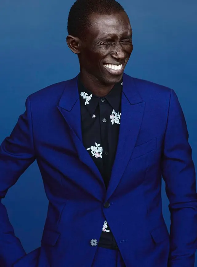 Fashion portrait with bold blue suit and floral embroidery, photographic, fashion, cool