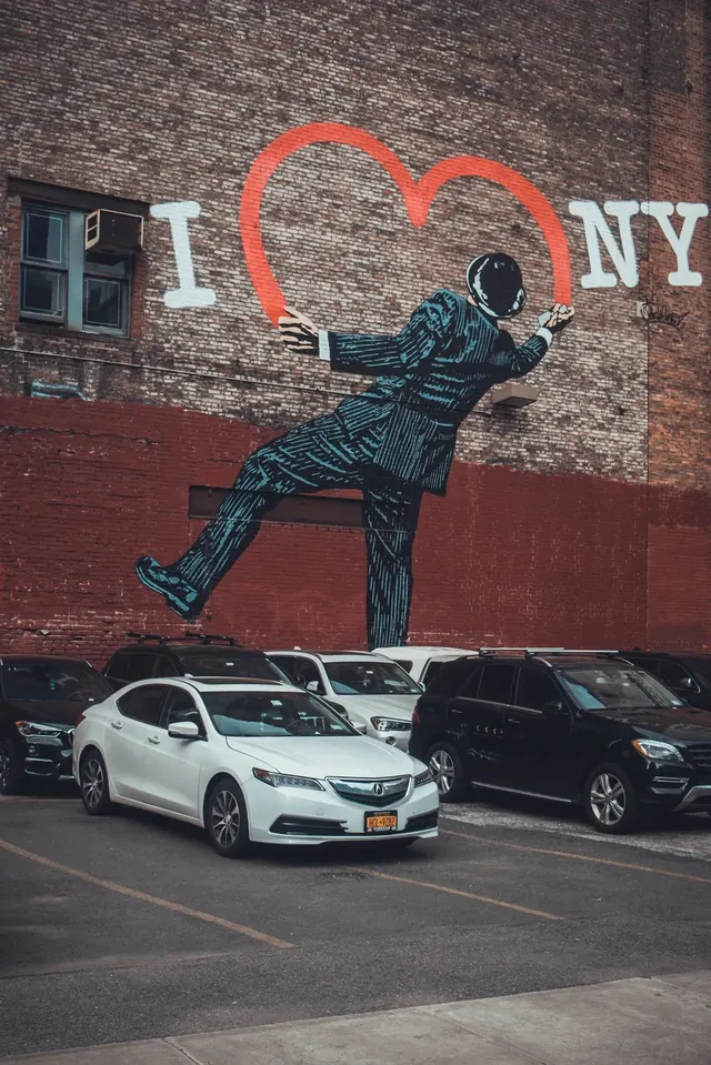 Urban street art mural of figure with heart, photographic, illustrative, warm