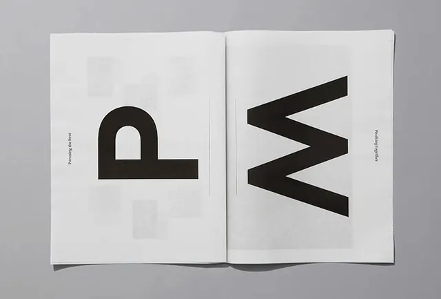 Open publication spread with geometric letter mark symbols, minimal, geometric, monochrome
