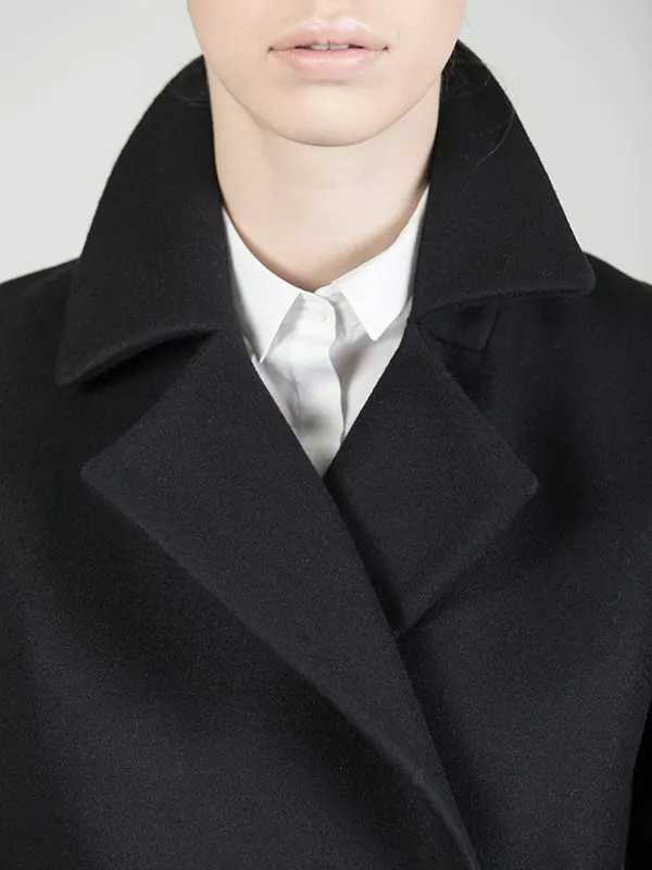 Minimalist fashion portrait with black coat and cropped head, photographic, minimal, monochrome