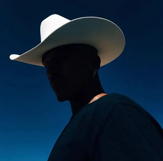 Silhouette portrait with white cowboy hat, photographic, minimal, dark