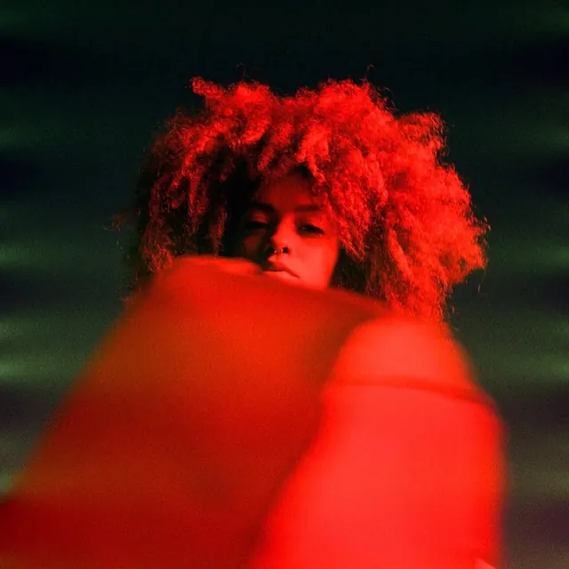 High-contrast portrait with red light effect, photographic, dramatic, vibrant