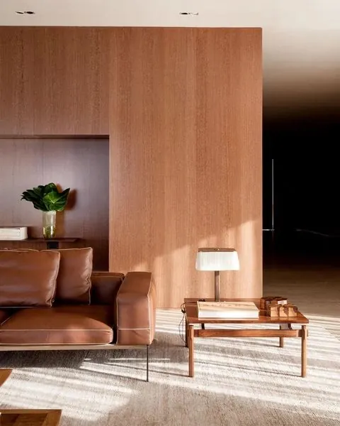 Warm modernist interior with leather furnishings, photographic, minimalist, warm