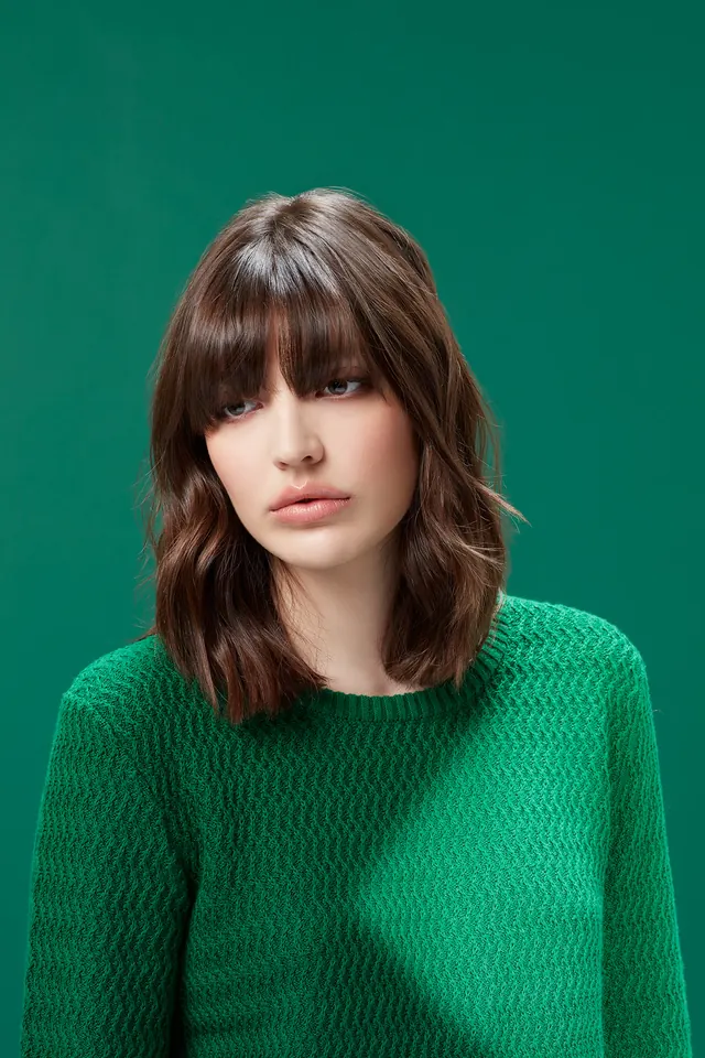Portrait photography with vibrant teal background, photographic, light-mode, vibrant
