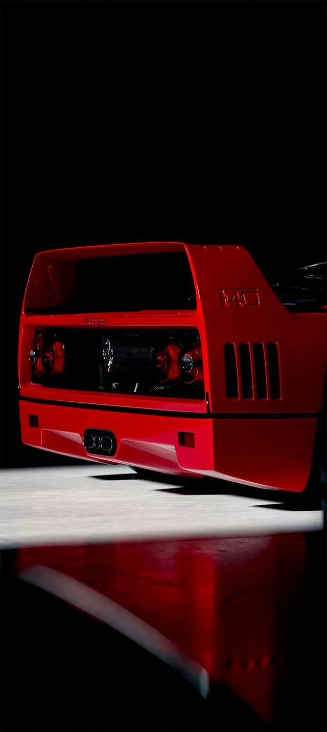 Automotive detail photograph of classic red car rear, photographic, technical, dark