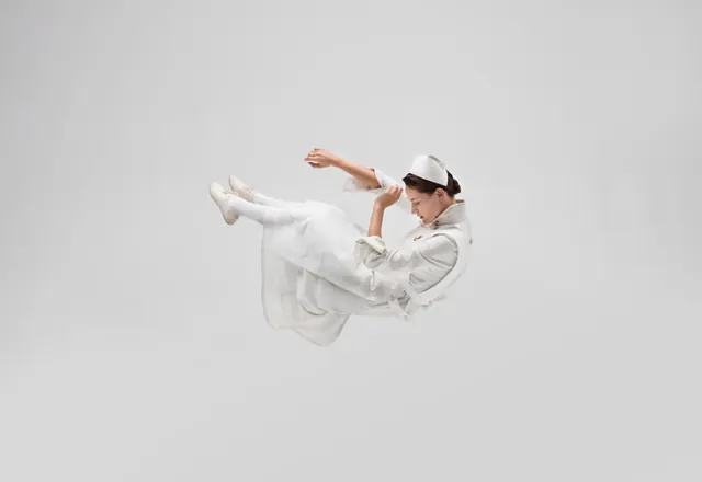 Overhead aerial figure in white clothing, photographic, minimal, light