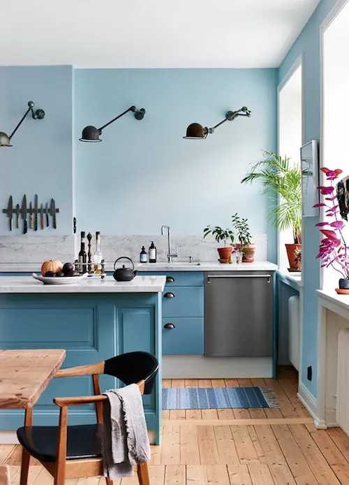 Modern blue kitchen with sculptural wall sconces, photographic, minimalist, cool