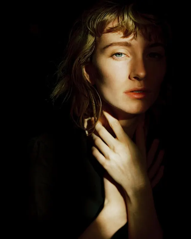 Female portrait dramatic studio lighting, photographic, professional, warm