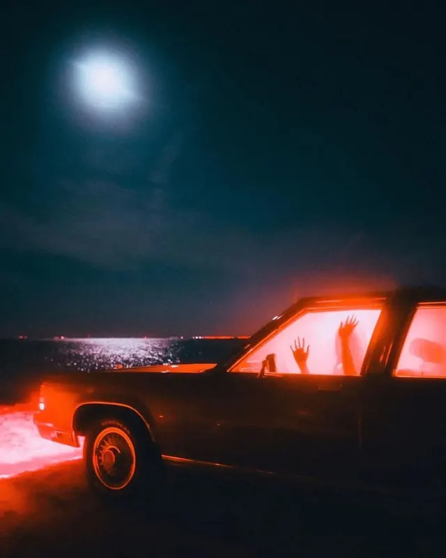 Moonlit vintage car with hands in window, photographic, surreal, dark