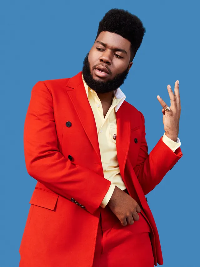 Male portrait red blazer blue background, photographic, professional, vibrant