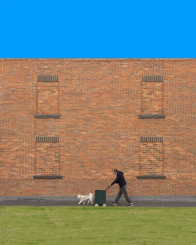 Minimalist urban portrait with blue sky, minimalist, photographic, high-contrast