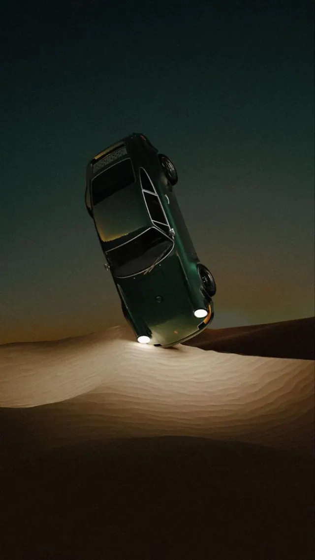 Car tilted on desert sand art photograph, photographic, surreal, warm