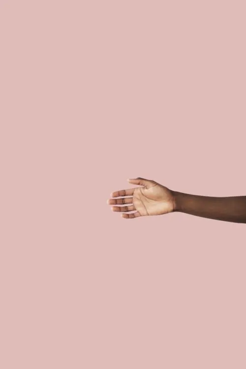 Hand reaching out on pastel background, minimal, photographic, pastel