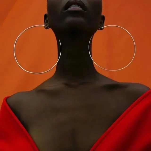 Fashion portrait with graphic earrings, photographic, editorial, vibrant