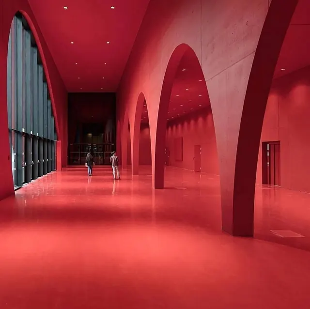 Red arcade corridor with archways, minimalist, photographic, vibrant
