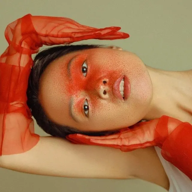 Portrait with red fabric editorial styling, photographic, editorial, warm