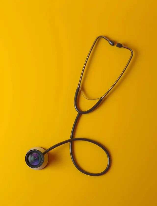Stethoscope on bright yellow background, photographic, minimalist, vibrant